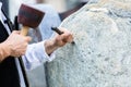 Sculptor with mallet and cutter working on erratic block Royalty Free Stock Photo