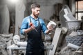 Sculptor with a piece of stone in the studio