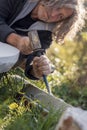 Sculptor sculpting with chisel and hammer in marble