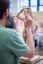 The sculptor sculpts a man`s sculpture from nature. Vertical frame