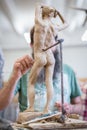 The sculptor sculpts a man`s sculpture from nature. Vertical frame