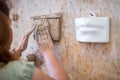 A sculptor sculpts a sculpture of her mouth. Horizontal frame