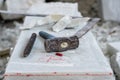 Sculptor tools on a marble slab, close up. Workplace, traditional tools sculptor, red chalk, ruler, hammer and chisel for working