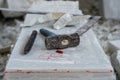 Sculptor tools on a marble slab, close up. Workplace, traditional tools sculptor, red chalk, ruler, hammer and chisel for working