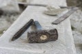 Sculptor tools on a marble slab, close up. Workplace, traditional tools sculptor, red chalk, ruler, hammer and chisel for working