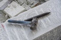 Sculptor tools on a marble slab, close up. Workplace, traditional tools sculptor, red chalk, ruler, hammer and chisel for working