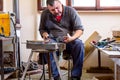 Artist is making figure by welding few metal wires in his workshop, barehanded