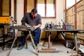 Artist is making figure by welding few metal wires in his workshop, barehanded