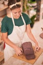 Sculptor woman, cut clay and table in workshop for artistic vision, development or pottery product. Creative artist lady