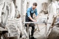 Sculptor working with laptop in the studio Royalty Free Stock Photo