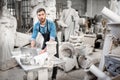 Sculptor working with laptop in the studio Royalty Free Stock Photo