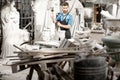 Sculptor working with sculptuers in the studio Royalty Free Stock Photo