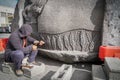 Sculptor works on a big stone Royalty Free Stock Photo