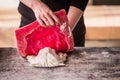 The sculptor works in a plaster workshop. Separates the silicone mold from the plaster sculpture of the lion`s head