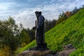 Sculptural composition `Fisherman and his cat` on the banks of the volkhov river in front of Staroladozhsky Nikolsky male monaster Royalty Free Stock Photo