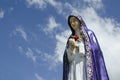 Sculptural composition of Our Lady of Sorrows at shrine isolated on blue sky