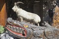 Sculptural composition of a stuffed goat and carved wooden crocodile at the foot of the tower on a mountain Big Ahun, Sochi