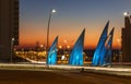 Sculptural group sails with changing colors at sunset in Ashdod