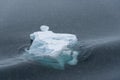 Sculptural iceberg shrouded in fog and floating in the dark waters of Antarctica Royalty Free Stock Photo