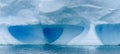Sculptural iceberg shrouded in fog and floating in the waters of Antarctica Royalty Free Stock Photo