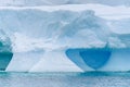 Sculptural iceberg shrouded in fog and floating in the waters of Antarctica Royalty Free Stock Photo