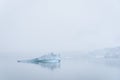 Sculptural iceberg shrouded in fog and floating in the waters of Antarctica Royalty Free Stock Photo