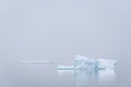 Sculptural iceberg shrouded in fog and floating in the waters of Antarctica Royalty Free Stock Photo