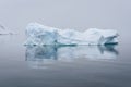 Sculptural iceberg shrouded in fog and floating in the waters of Antarctica Royalty Free Stock Photo