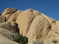 Sculptural Mojave Desert rock formations under a clear blue winter sky