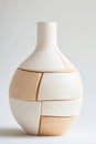 Sculptural vase with segmented sections of light cream and sandy beige tones, featuring a textured finish and a smooth neck Royalty Free Stock Photo