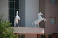 Sculptural white figures of two rearing horses above the entrance to the building. Kemer Resort