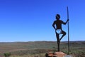 Sculpture of Aboriginal Australian male standing on a rock in Roebourne lookout in Western Australia