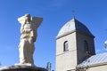 Sculpture of an angel on the background of the Church of the Exaltation of the Holy Cross of the XVI century in Ternopil Ukraine.