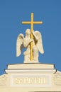 Sculpture of an angel with a cross.