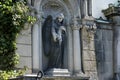 Sculpture of an Angel with flowers roses in her hand on a family tomb / crypt at the cemetery at Suedstern