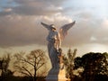 Sculpture of an angel of glory in a sunset. Royalty Free Stock Photo