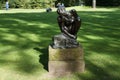 The sculpture by Auguste Rodin stands in the park