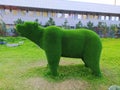 Sculpture of a bear in the Park against the trees Royalty Free Stock Photo