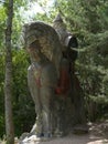 Sculpture of a bearded bogatyr in red boots on a horse. Beautiful, in the Slavic style