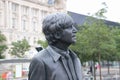 Sculpture of the Beatles on Pier Head, Liverpool, England, in rainy weather. Detail: Portrait of John Lennon