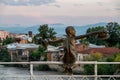 Sculpture of a boy with hats on White bridge over Rioni river in Kutaisi Royalty Free Stock Photo