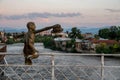 Sculpture of a boy with hats on White bridge over Rioni river in Kutaisi Royalty Free Stock Photo