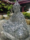 Sculpture Buddha head made of hollow iron. Vertical photo image.