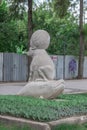 Sculpture bull buffalo sit on fur seal fish with planet around its neck rear view in Karaalioglu park Antalya Turkey