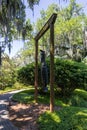 A sculpture called Travelin Light by Alison Saar with lush green trees, grass and plants and blue sky in Sculpture Garden Royalty Free Stock Photo