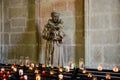 Sculpture and candles in La basilique Saint-Nazaire of the city