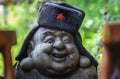 Sculpture of a Chinese figure wearing wooly hat with a red communist star emblem