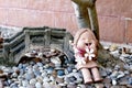 Sculpture clay girl with plumeria flower in the garden