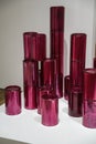 A sculpture composed of a pile of red transparent acrylic tubes