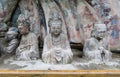 Statues of disciples or followers in front of giant Buddhan at Dazu Rock Carvings Royalty Free Stock Photo